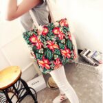 Mehrfarbige, florale Strandtasche für Frauen mit einer Frau, die die Tasche trägt