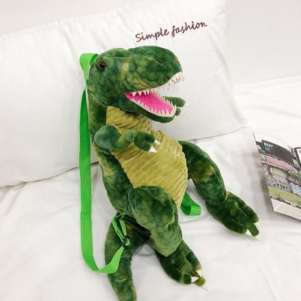 Original 3D-Dinosaurier-Rucksack Grün In Einem Weißen Bett
