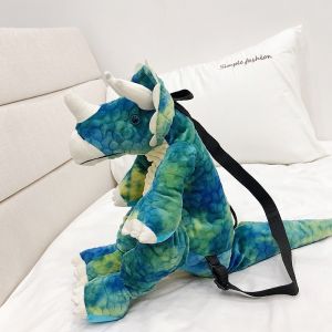 Original 3D Dinosaurier Rucksack grün mit einem weißen Bett Hintergrund